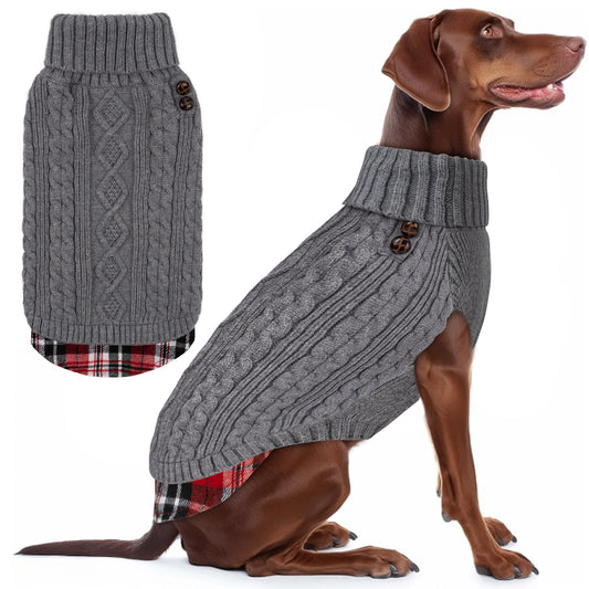 Brown dog seated in a gray cable knit turtleneck sweater with plaid hem, side view