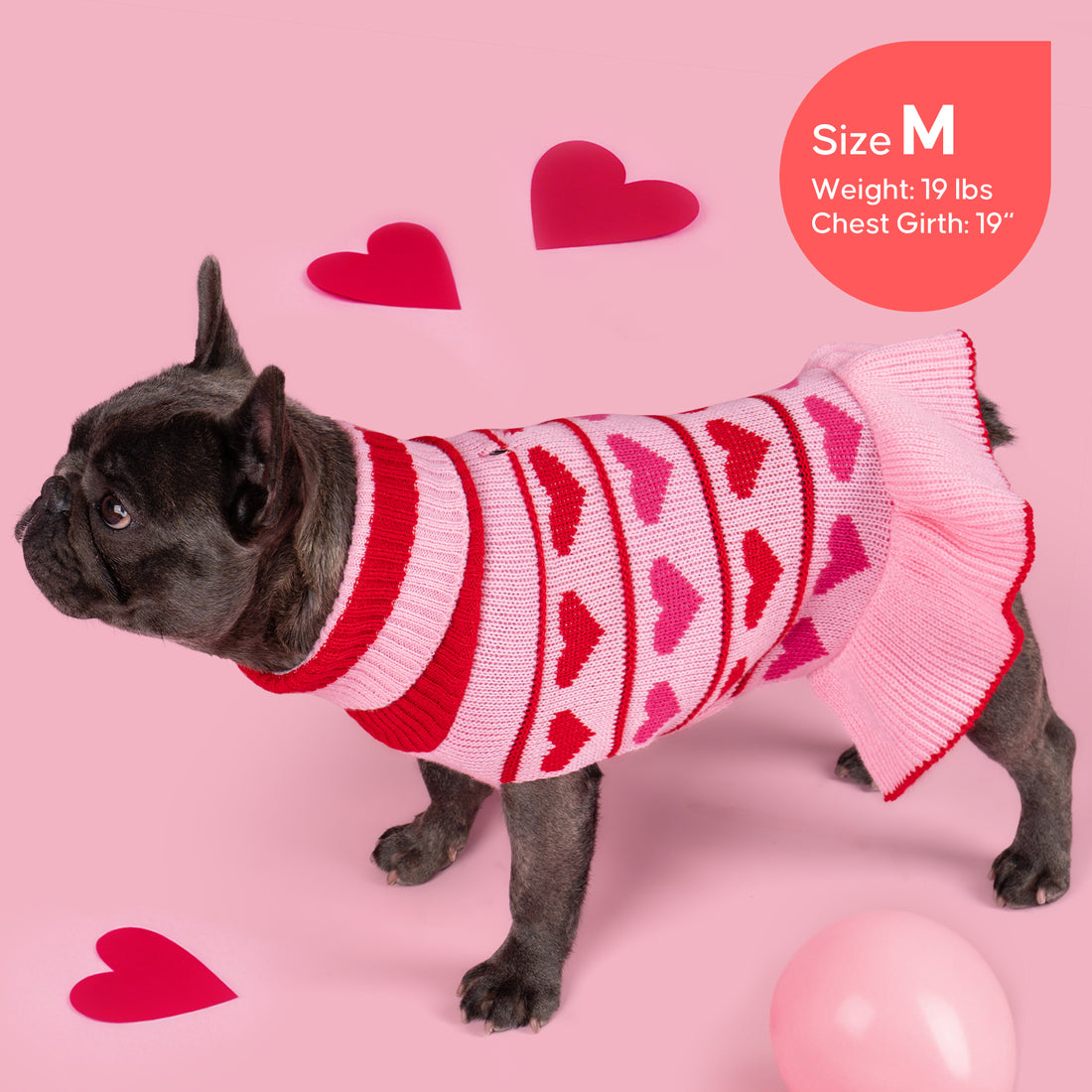 Pink dog sweater dress with red heart stripes, ribbed turtleneck, and flared cuffs