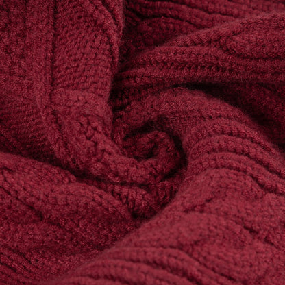 Close-up of burgundy knitted fabric showing raised cable stitch texture