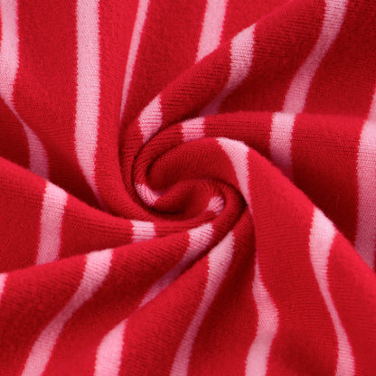 Close-up of soft red fabric with narrow white stripes twisted into a spiral