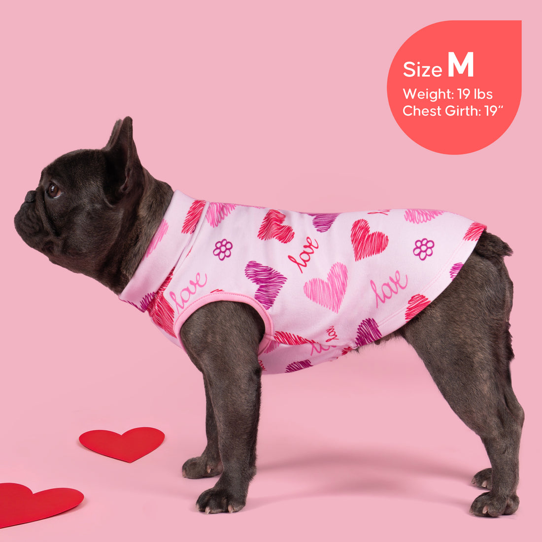 Sleeveless dog shirt with white base, pink heart scribble print and paw icons