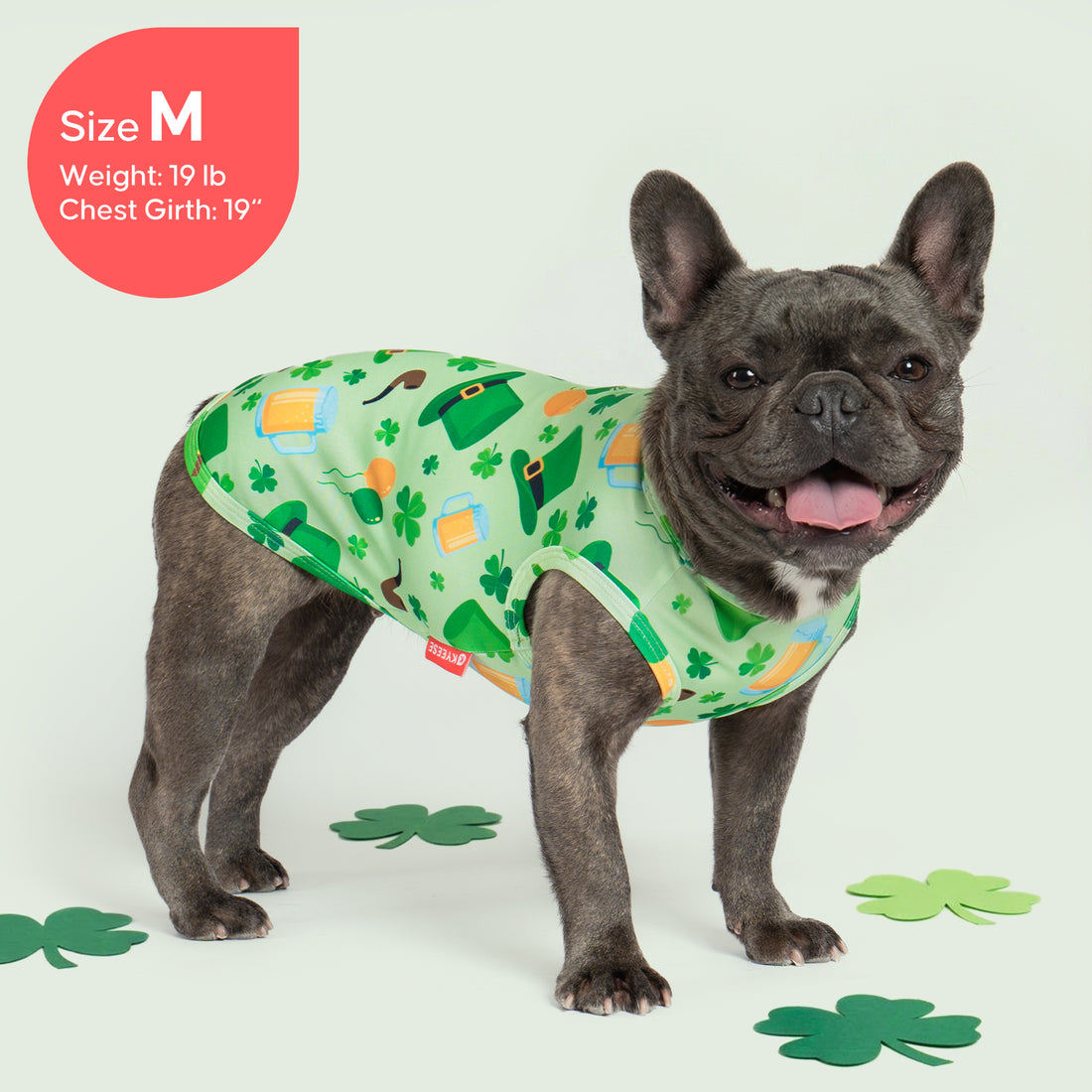 White sleeveless dog shirt with green shamrock and leprechaun hat pattern