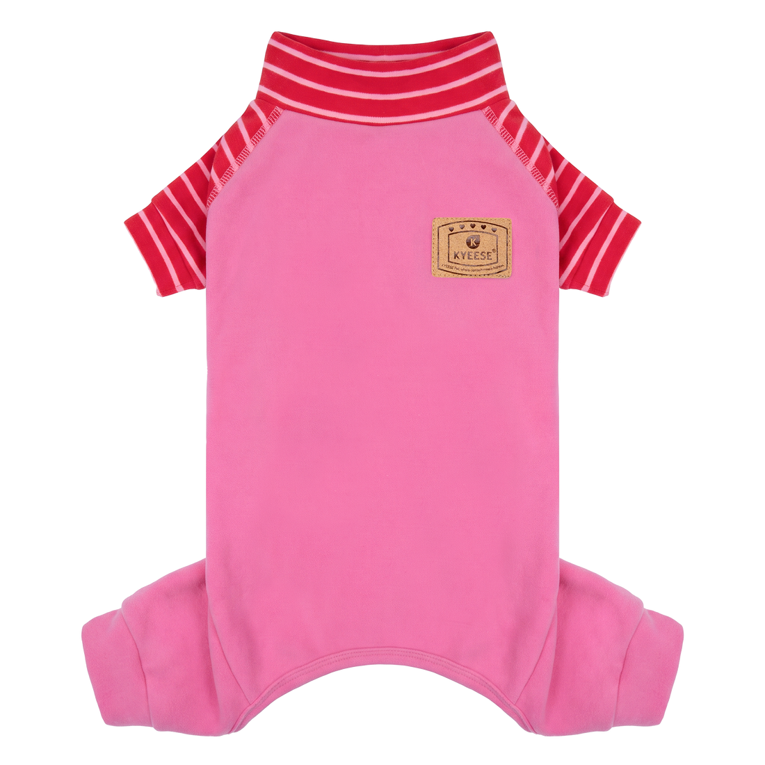 Small tan dog seated outdoors wearing pink pajamas with red striped sleeves