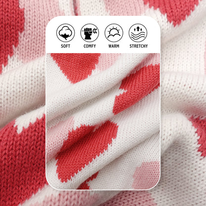 Close-up knit dog sweater fabric with white base and red heart pattern