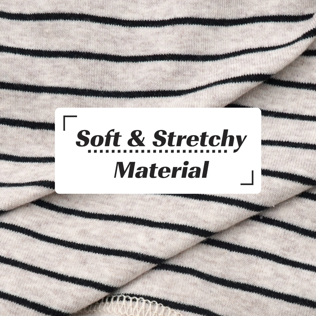 Striped dog onesie fabric close-up, soft knit with black horizontal stripes