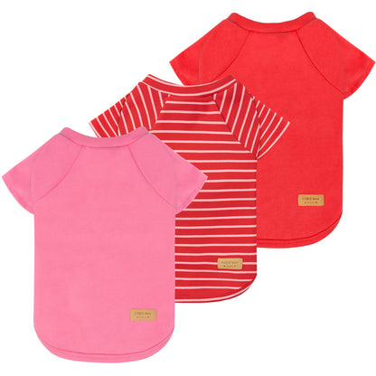 Three dog shirts: pink solid, red solid, and red-and-white striped raglan