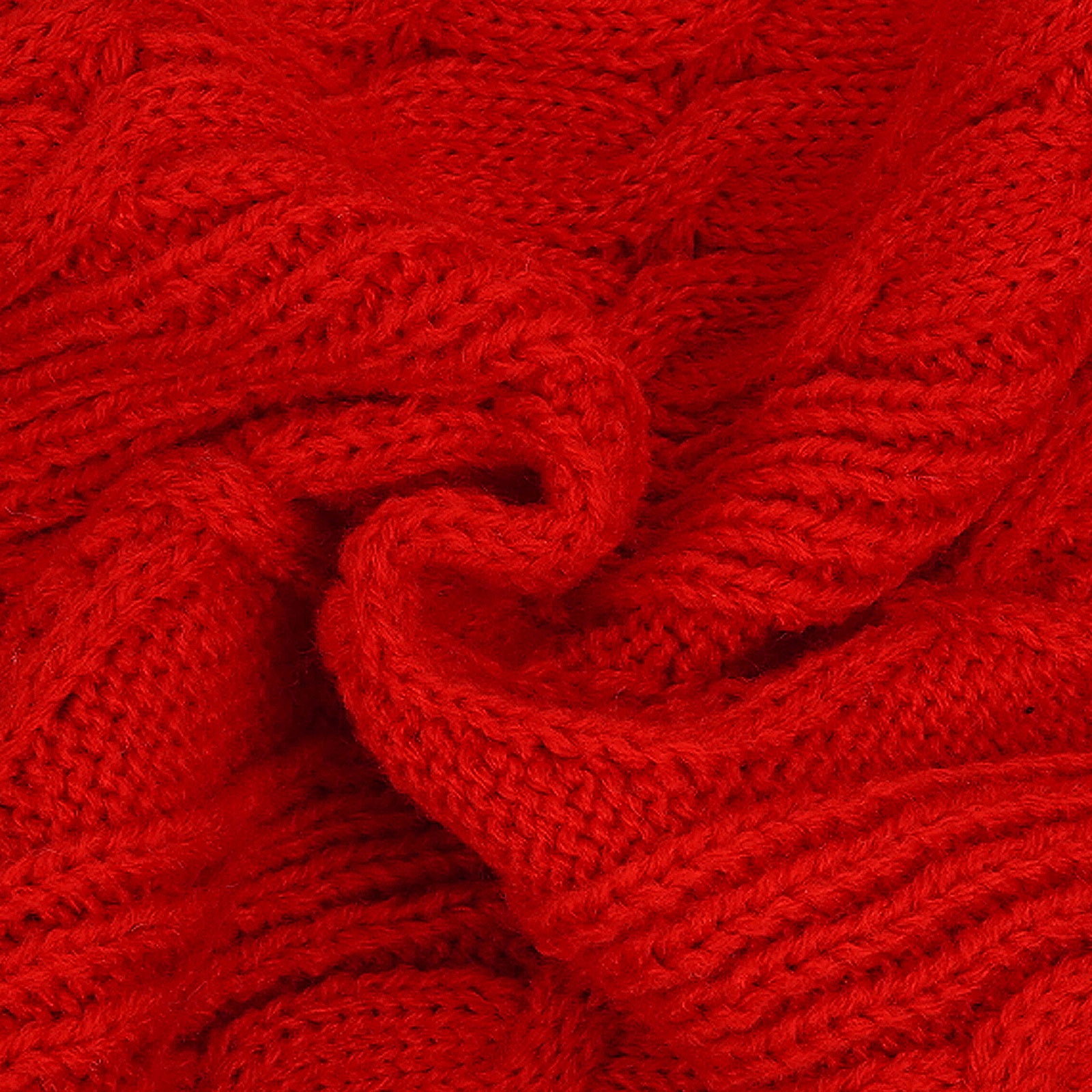 Red cable knit sweater fabric close-up with raised interlaced pattern