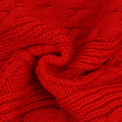 Red cable knit sweater fabric close-up with raised interlaced pattern
