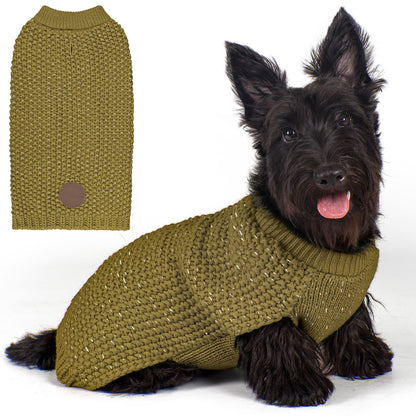 Olive knit dog sweater with round neck and small patch, worn by a sitting dog