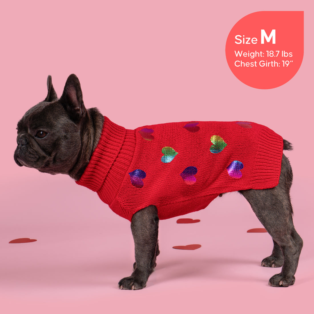 Red knit dog sweater with multicolor heart motifs and ribbed sleeves