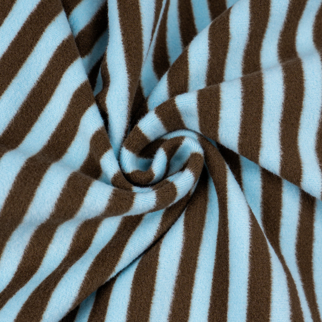 Brown-and-blue striped fleece fabric close-up with stitched swirl fold