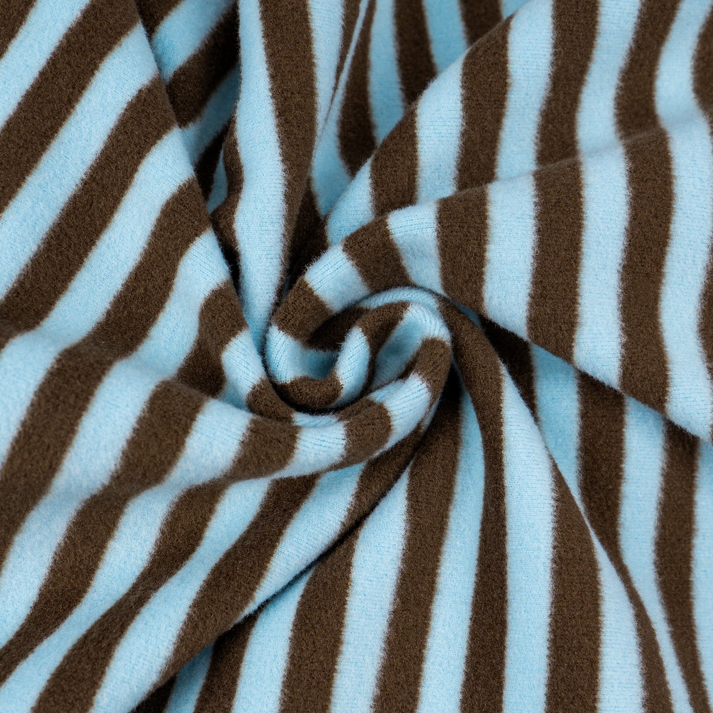 Brown-and-blue striped fleece fabric close-up with stitched swirl fold