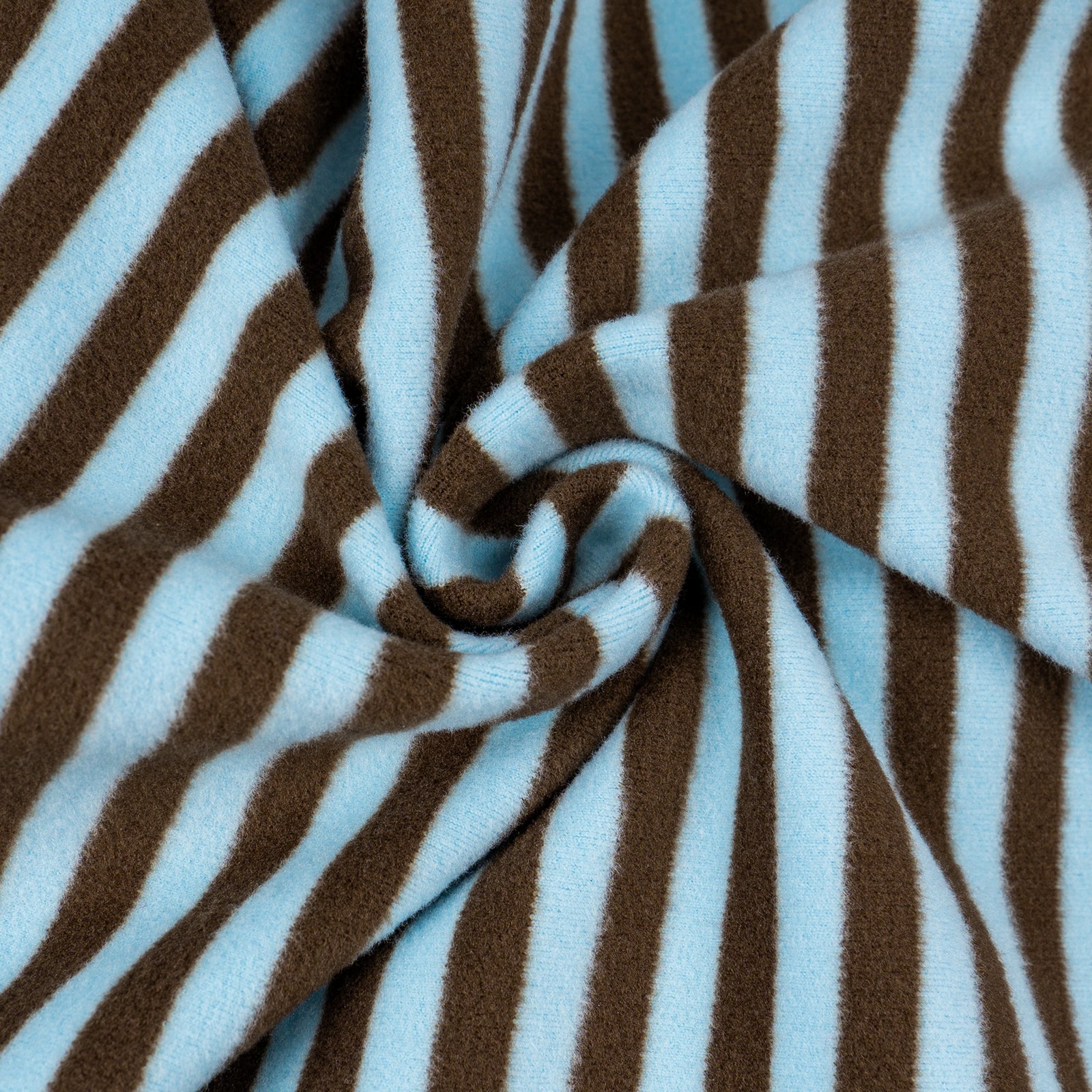 Brown-and-blue striped fleece fabric close-up with stitched swirl fold