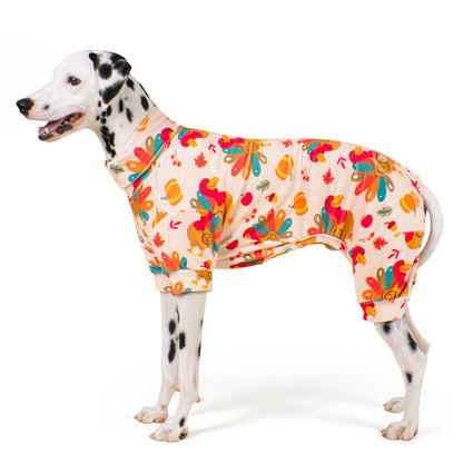 Dog onesie pajamas in cream with colorful turkey, leaf, and pumpkin pattern