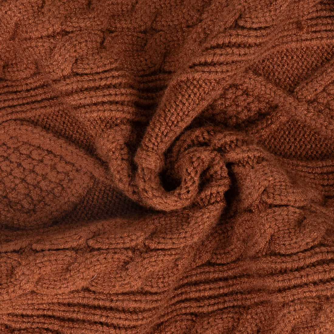 Brown cable knit dog sweater fabric close-up with textured cable pattern