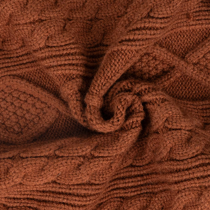 Brown cable knit dog sweater fabric close-up with textured cable pattern