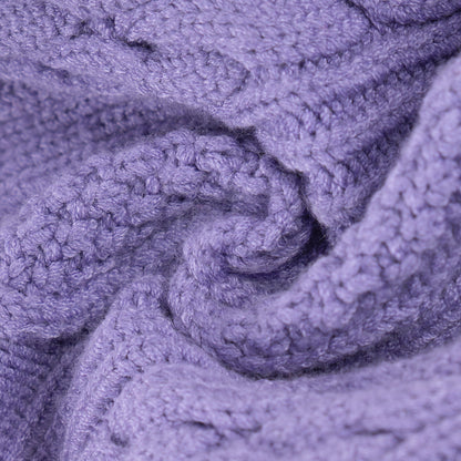 Close-up of raised cable stitches in light purple knit fabric
