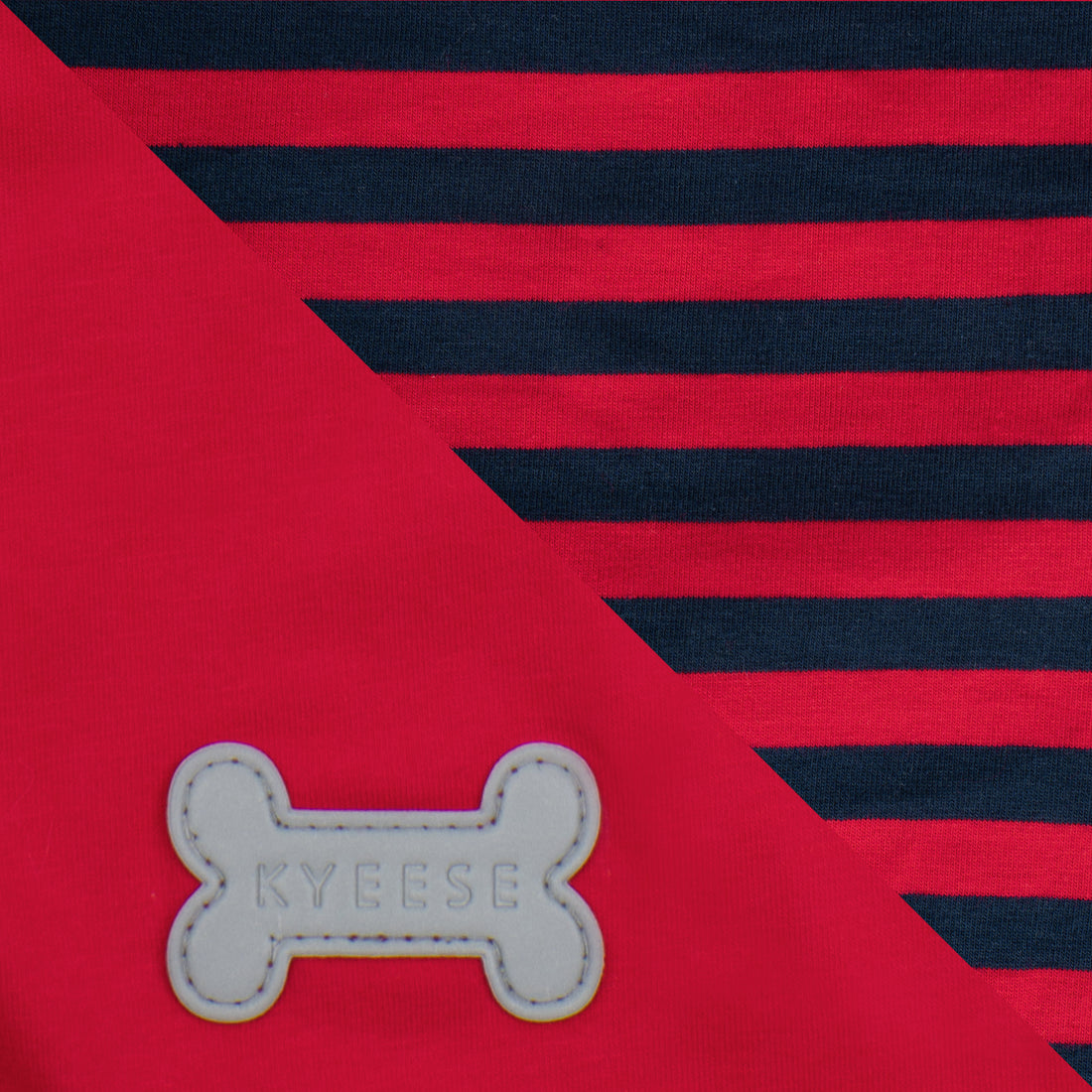 Close-up of navy stripes on red fabric and reflective bone logo
