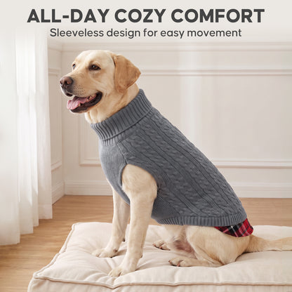 Golden Retriever sitting indoors in a grey sleeveless cable knit turtleneck dog sweater with plaid hem
