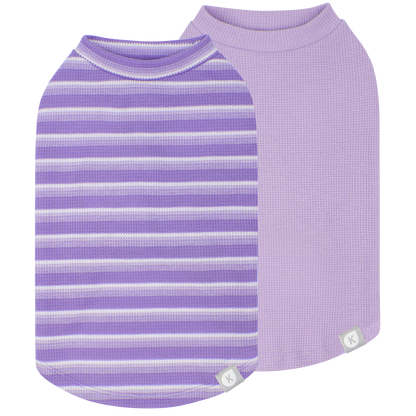 Purple striped and solid lavender sleeveless dog shirts shown on black background